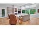 Bright living room features hardwood floors, fireplace, built-in shelving and a large window at 5903 Birchwood Ave, Indianapolis, IN 46220