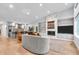 Open concept living room featuring modern fireplace, hardwood floors, and gourmet kitchen at 5903 Birchwood Ave, Indianapolis, IN 46220