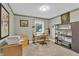 Well-lit home office featuring a wooden desk, printer, and bookshelf at 5903 Birchwood Ave, Indianapolis, IN 46220