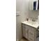 Bathroom vanity features classic hardware, patterned wallpaper, and ample storage at 6408 W Taylor Rd, Muncie, IN 47304