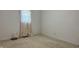 An empty bedroom with light carpet, light walls, and window with a curtain at 6408 W Taylor Rd, Muncie, IN 47304