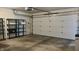 Clean garage features an automatic door, storage shelving, and concrete floors at 6408 W Taylor Rd, Muncie, IN 47304