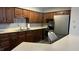The kitchen features wood cabinets, stainless steel appliances, ample counter space, and tile flooring at 6408 W Taylor Rd, Muncie, IN 47304
