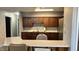 Features a breakfast bar, wooden cabinetry, updated countertops, stainless steel refrigerator, and ample storage at 6408 W Taylor Rd, Muncie, IN 47304