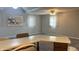 Large living room features neutral carpet, ceiling fan, and ample space for furniture and a breakfast bar at 6408 W Taylor Rd, Muncie, IN 47304