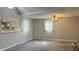 The room has high ceilings, a ceiling fan, carpet flooring, and two windows for plenty of light at 6408 W Taylor Rd, Muncie, IN 47304