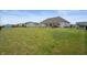 Wide backyard view from home, showing a large lawn and neighboring houses at 6420 Colt Ln, Anderson, IN 46013