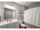 Well-maintained bathroom with a single sink vanity, a toilet, and a shower with curtain and neutral color palette at 6420 Colt Ln, Anderson, IN 46013