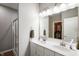 Bathroom with dual sinks, white cabinets, and a glass-enclosed shower for a modern and functional space at 6420 Colt Ln, Anderson, IN 46013