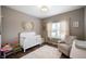 Cozy Bedroom with a crib, a comfortable chair, neutral colors, and soft textures for a warm environment at 6420 Colt Ln, Anderson, IN 46013