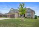 Beautiful brick home with a well-maintained lawn and a young tree in the front yard at 6420 Colt Ln, Anderson, IN 46013