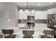 Modern kitchen with white cabinets, stainless steel appliances, and a center island with seating at 6420 Colt Ln, Anderson, IN 46013