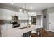 Bright kitchen with white cabinets, stainless steel appliances, and a large center island at 6420 Colt Ln, Anderson, IN 46013
