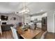 Open concept kitchen and living area featuring stainless steel appliances, white cabinets, and a dining table at 6420 Colt Ln, Anderson, IN 46013