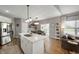 Open-concept kitchen with white cabinets, stainless steel appliances, and a large island with a sink at 6420 Colt Ln, Anderson, IN 46013