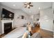 Cozy living room featuring a fireplace, open layout, and view into the kitchen at 6420 Colt Ln, Anderson, IN 46013