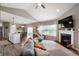 Spacious living room featuring a fireplace, high ceilings, and lots of natural light at 6420 Colt Ln, Anderson, IN 46013