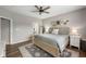 Spacious main bedroom with a large bed, neutral tones, ensuite bathroom, and natural light from windows at 6420 Colt Ln, Anderson, IN 46013