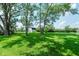 Lush backyard featuring mature trees, green grass, and a storage shed at 6550 Reed Rd, Pittsboro, IN 46167