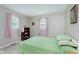 The bedroom boasts neutral walls, carpet, with pink curtains, a bookshelf, and a window that invites natural light at 6550 Reed Rd, Pittsboro, IN 46167