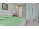 Bedroom boasts neutral walls, carpet, green bedding, and a closet for storage, and access to an ensuite bath at 6550 Reed Rd, Pittsboro, IN 46167