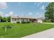 Inviting home exterior with a well-maintained lawn, mature trees, and a charming front porch at 6550 Reed Rd, Pittsboro, IN 46167