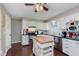 Well-lit kitchen featuring white cabinetry, stainless steel appliances, and a versatile kitchen island at 6550 Reed Rd, Pittsboro, IN 46167