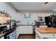 Functional kitchen with white cabinets, dark countertops, and stainless steel appliances at 6550 Reed Rd, Pittsboro, IN 46167
