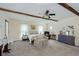 Spacious bedroom with exposed ceiling beams, neutral walls, carpet flooring, sitting area, and natural light at 6550 Reed Rd, Pittsboro, IN 46167