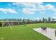 Spacious backyard featuring a playset, lush lawn, stone fire pit, and a secure wood fence at 6589 Kara Ln, Brownsburg, IN 46112