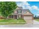 Charming two-story home with brick accents, a well-maintained lawn, and an attached two-car garage at 6589 Kara Ln, Brownsburg, IN 46112