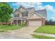 Beautiful two-story home featuring a brick and vinyl exterior, attached two-car garage, and well-manicured lawn at 6589 Kara Ln, Brownsburg, IN 46112