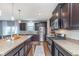 Bright kitchen featuring stainless steel appliances, granite countertops, dark wood cabinets, and hardwood floors at 6589 Kara Ln, Brownsburg, IN 46112