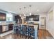 Beautiful kitchen with a center island, dark wood cabinets, granite countertops, and stainless steel appliances at 6589 Kara Ln, Brownsburg, IN 46112