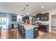 Modern kitchen featuring a large island with granite countertops, stainless steel appliances, and dark wood cabinetry at 6589 Kara Ln, Brownsburg, IN 46112