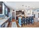 Lovely kitchen with a large center island, granite countertops, stainless steel appliances, and wooden floors at 6589 Kara Ln, Brownsburg, IN 46112