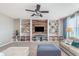 Inviting living room features built-in shelving, ceiling fan, and a cozy seating area at 6589 Kara Ln, Brownsburg, IN 46112