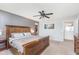 Spacious main bedroom with large bed, ceiling fan, and access to the ensuite bathroom at 6589 Kara Ln, Brownsburg, IN 46112