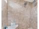 Close-up of the bathroom shower with tan tile and shower products at 6589 Kara Ln, Brownsburg, IN 46112