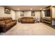 Large basement rec room featuring comfortable couches, mounted television, and playful decor at 7128 Verwood Ct, Plainfield, IN 46168