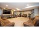 Spacious basement rec room with comfortable seating, a mounted television, and neutral carpeting at 7128 Verwood Ct, Plainfield, IN 46168