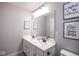 Bright bathroom featuring a double sink vanity, large mirror, and modern decor at 7128 Verwood Ct, Plainfield, IN 46168