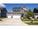 Charming two-story home with a three-car garage, manicured lawn, and beautiful architectural details at 7128 Verwood Ct, Plainfield, IN 46168