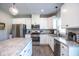 Bright kitchen boasts stainless steel appliances, white cabinetry, and a granite countertop island at 7128 Verwood Ct, Plainfield, IN 46168