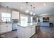 Bright kitchen featuring a center island with counter seating, stainless steel appliances and open access to living room at 7128 Verwood Ct, Plainfield, IN 46168