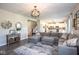 Cozy living room featuring a large sectional, stylish decor, and an open layout connecting to the kitchen at 7128 Verwood Ct, Plainfield, IN 46168
