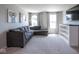 Comfortable living room featuring a large gray sectional sofa, bright windows, and stylish decor at 7128 Verwood Ct, Plainfield, IN 46168