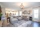 Open-concept living room features a large sectional couch, decor art, and leads into the kitchen at 7128 Verwood Ct, Plainfield, IN 46168