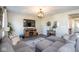 Comfortable living room featuring a sectional sofa, hardwood floors, and a mounted TV at 7128 Verwood Ct, Plainfield, IN 46168