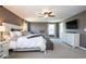 Spacious main bedroom with plush carpeting, a ceiling fan, and plenty of natural light from large windows at 7128 Verwood Ct, Plainfield, IN 46168
